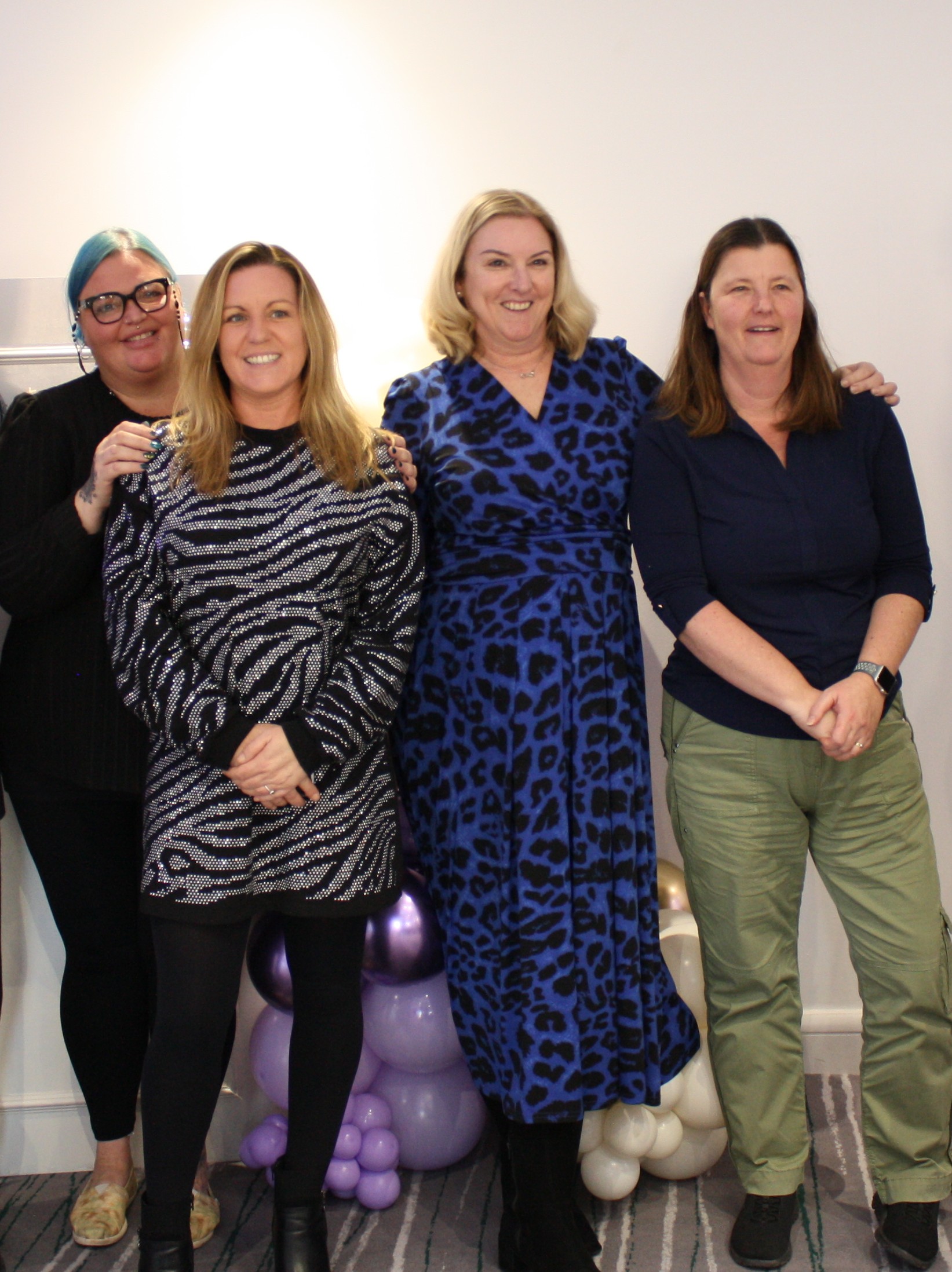 Janice stands with colleagues posing for a photo