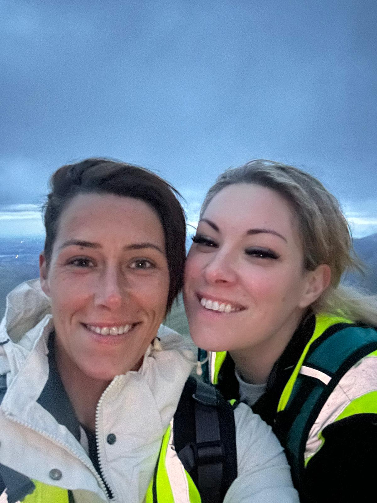 Sisters Krystal and Suzie smile at the camera at the top of Snowdon.
