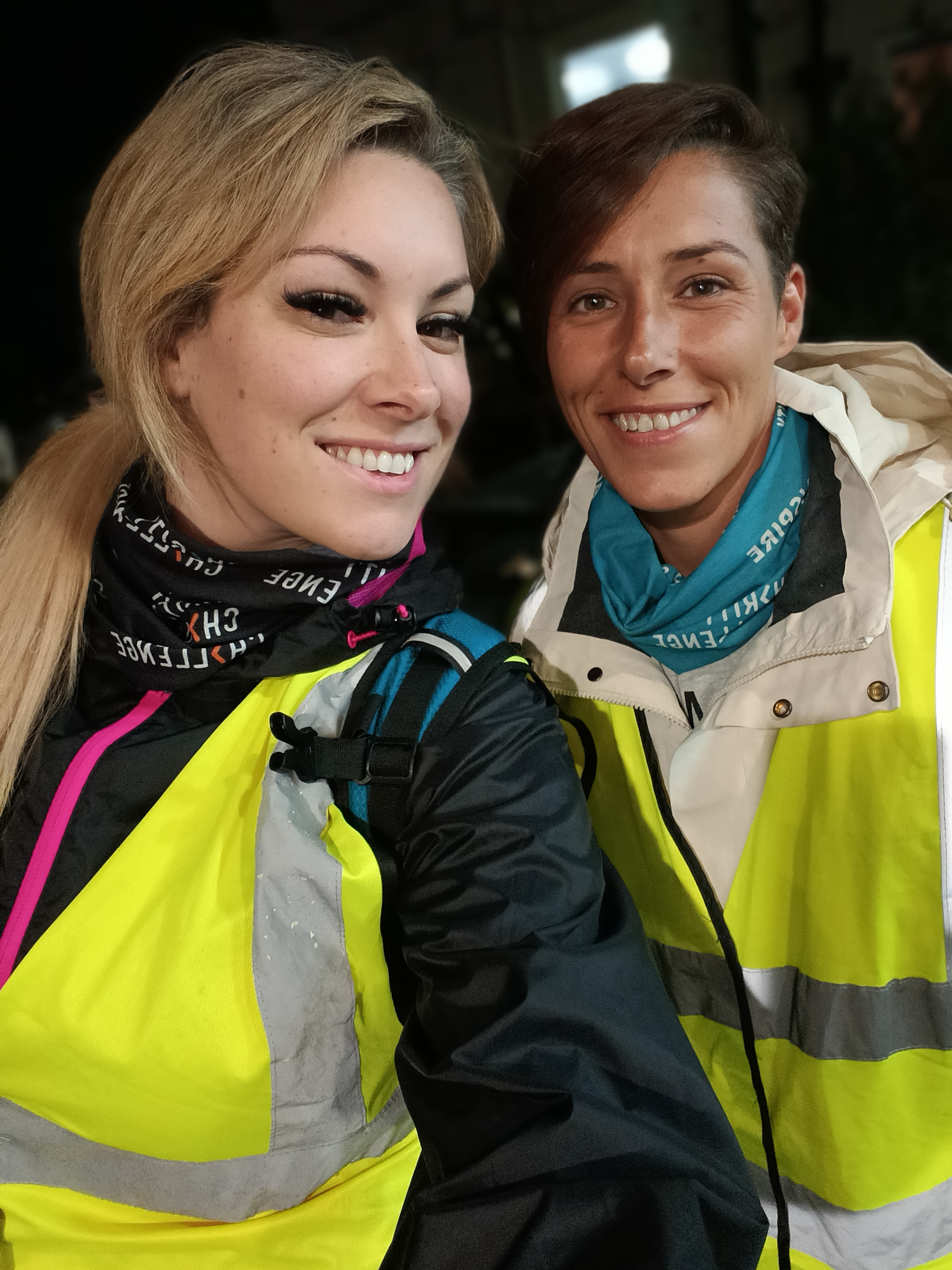 Sisters Krystal and Suzie smile at the camera in the dark as they trek Snowdon.